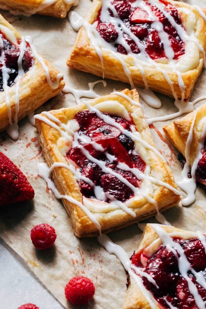 Bread pastry with strawberry filling topped with cream cheese.
