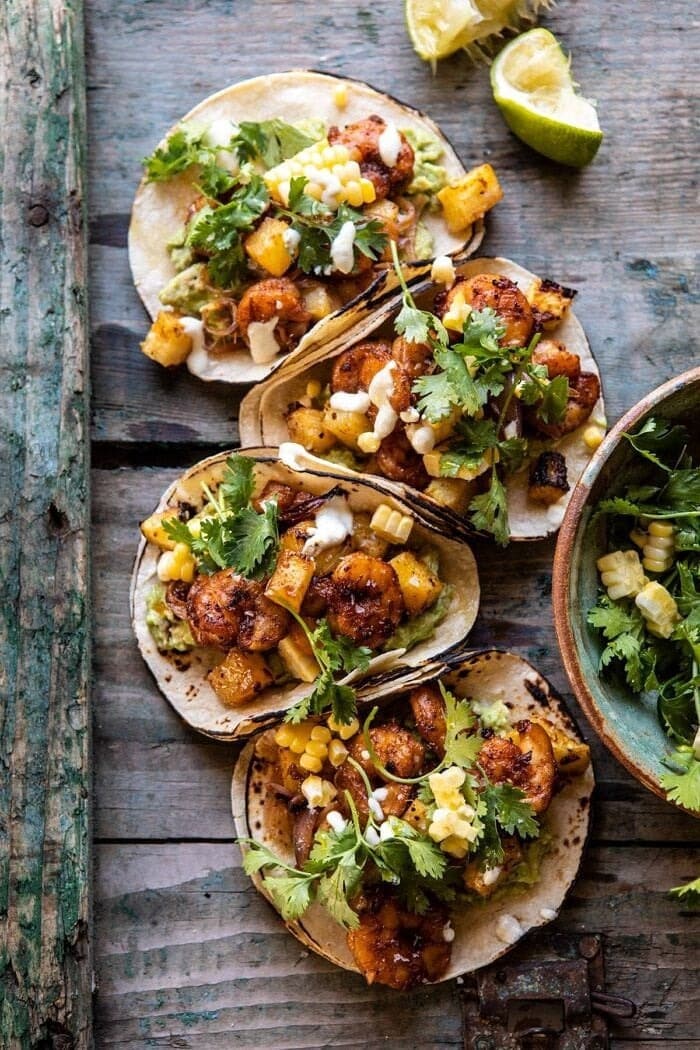 sheet-pan-hawaiian-pineapple-shrimp Sheet pan hawaiian pineapple shrimp tacos on top of wooden table.