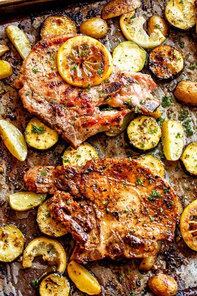 sheet-pan-lemon-pork-chops Lemon garlic baked pork chops with squash and potatoes on a sheet pan.