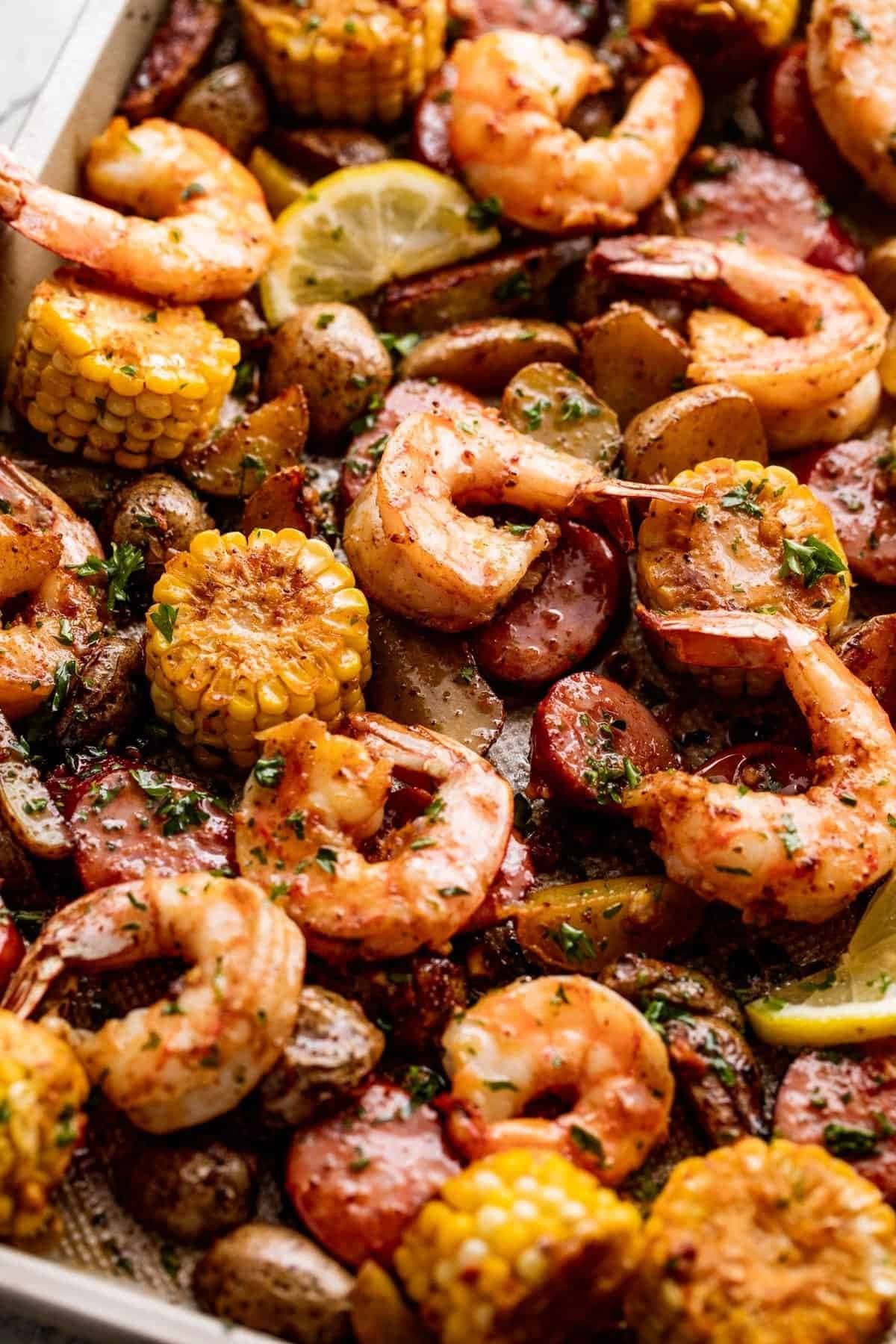 sheet-pan-shrimp-boil Shrimp broil with corn, potatoes, and sausage cooked in a sheet pan.