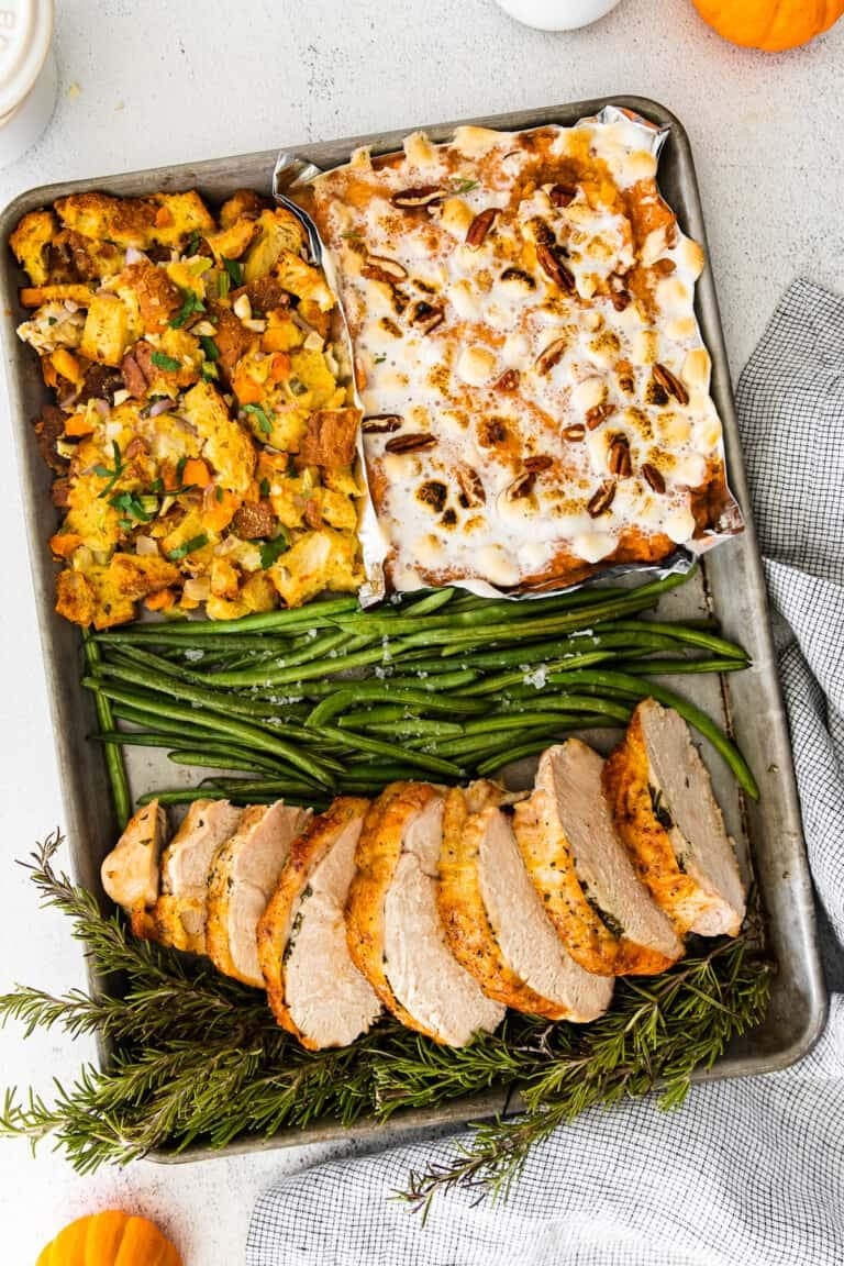 sheet-pan-thanksgiving Sliced turkey breast, stuffing, sweet potato casserole, and green beans on a sheet pan.