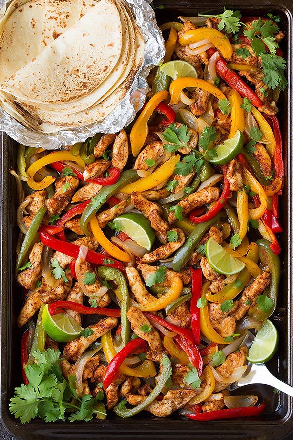 sheet_pan_fajitas Chicken fajitas with well-seasoned chicken breast, onions, and peppers cooked in a sheet pan.