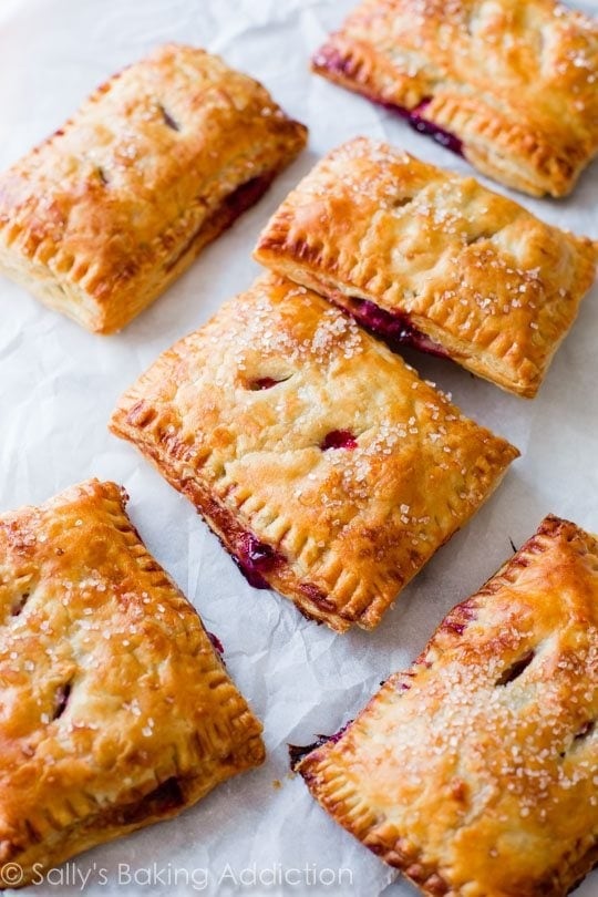 Toasted pastry pies with cherry filling sprinkled with white sugar.